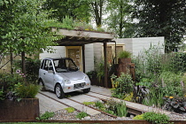 Hampton Court Flowershow 2009 'Rain Chain' garden designed by Wendy Allen incorporating parking for G-Wiz electric car under ?living? roof, rain garden and rear wall made from renewable resources.