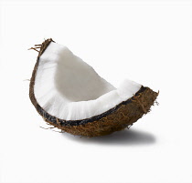 Coconut, Cocos nucifera, segment with shell with shadow against white background.