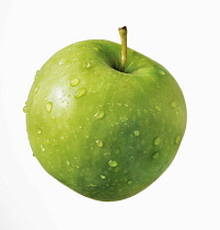Apple, Malus domestica 'Granny Smith', Cut out on white of a one green apple with droplets of water on it.