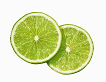 Lime. Citrus aurantiifolia, Plan view of two slices overlapping, cut out on white.