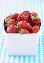 Strawberry, Fragaria x ananassa, Studio shot of red fruit in container.