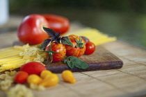 Tomato, Lycopersicon esculentum , Studio shot or red tomatoes on wooden board.