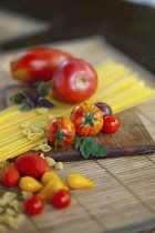 Tomato, Lycopersicon esculentum , Studio shot or red tomatoes on wooden board.