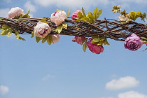 Rose, Rosa, Hanging floral decorations weaved into a wicker lattice.