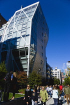 USA, New York, Manhattan, High Line linear park between buildings on a disused elevated railroad spur with people on a path beside the 23rd Street Lawn. USA, New York State, New York City.