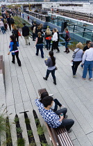 USA, New York, Manhattan, people walking among plants on the High Line linear park on an elevated disused railroad spur called The West Side Line beside the Hudson Rail Yards. USA, New York State, Ne...