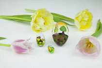 Studio shot of tulip flowers with painted eggs for Easter. Plants